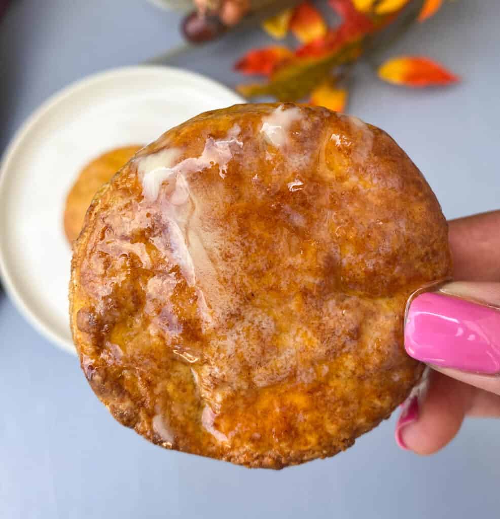 person holding sweet potato biscuit with butter and honey