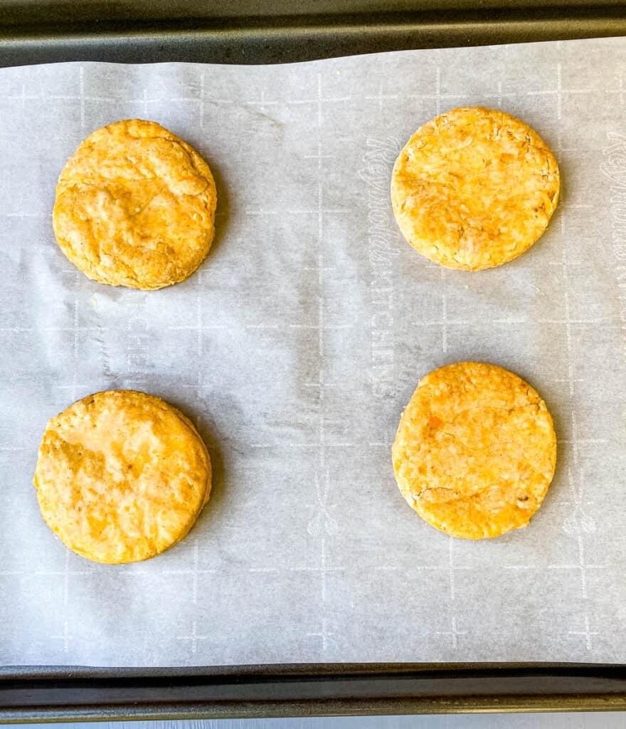 sweet potato biscuits on parchment paper and a sheet pan