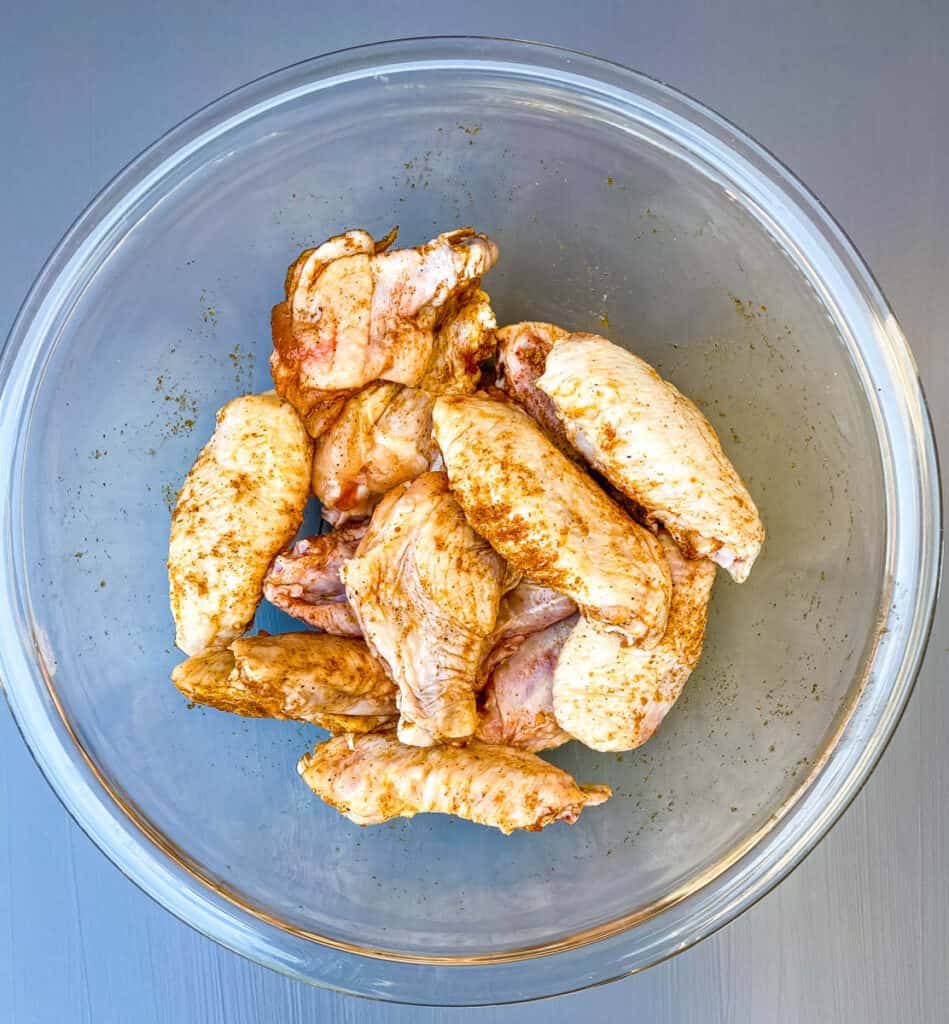 raw chicken wings in a glass bowl