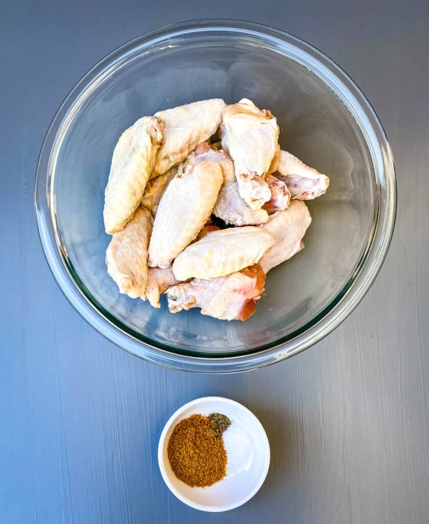 raw chicken wings in a glass bowl