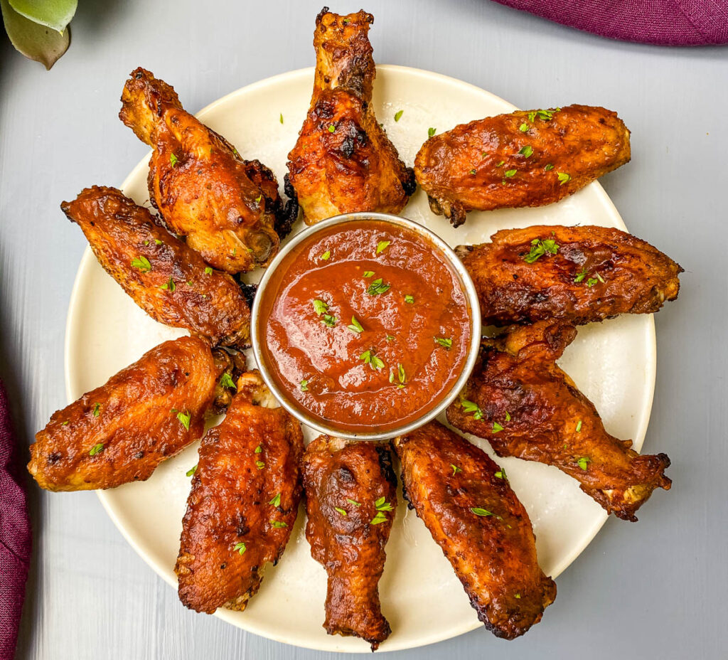 air fryer bbq chicken on a plate with bbq sauce