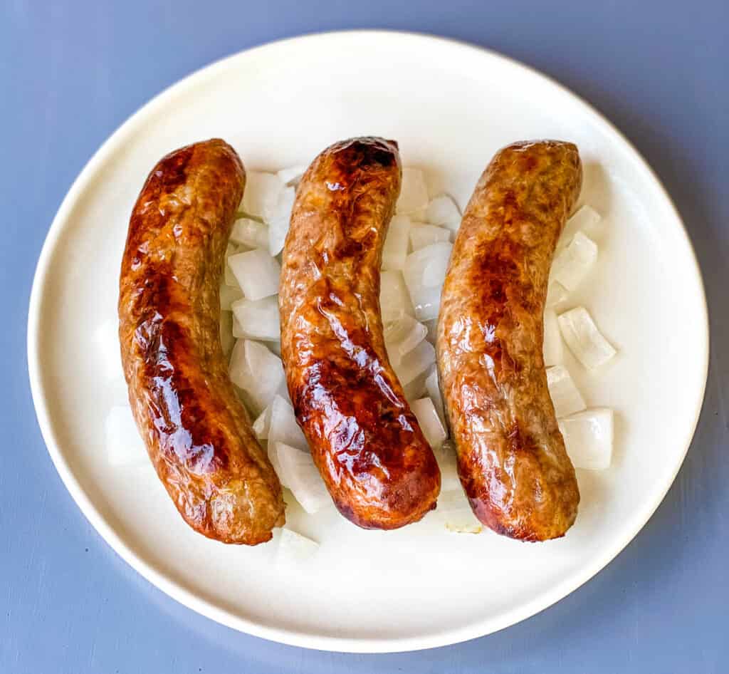 air fryer brats on a plate with onions