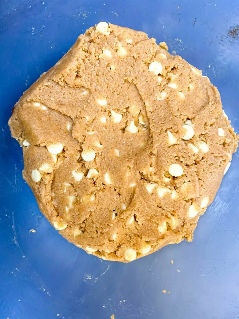 keto gingersnaps cookie dough with white chocolate chips in a glass bowl