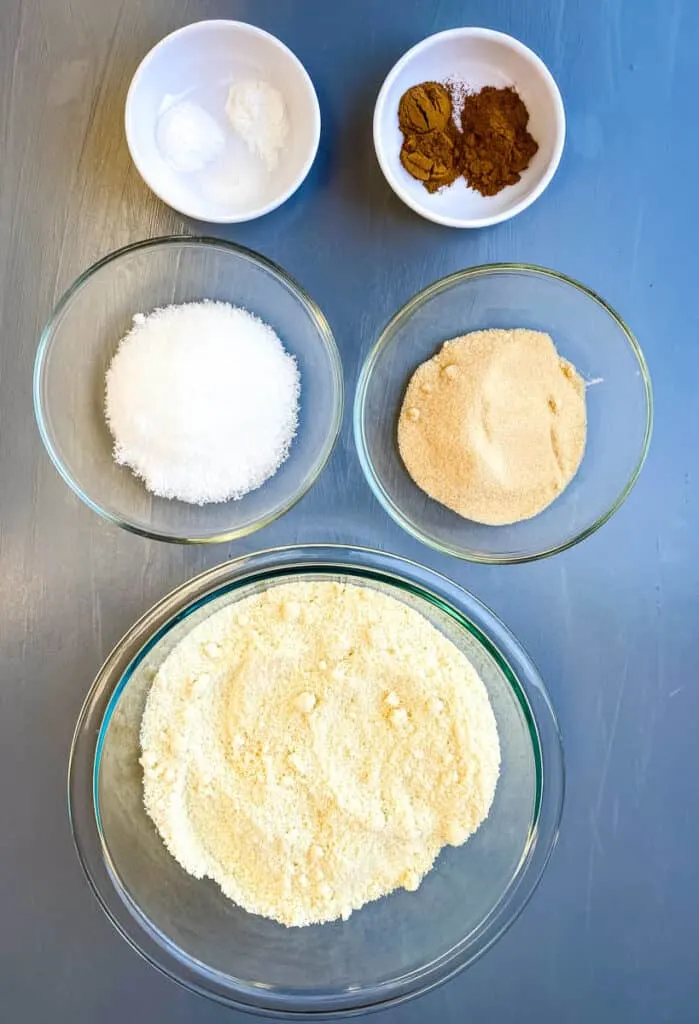 almond flour, golden sweetener, white sweetener, pumpkin pie spice, baking powder, and baking soda in separate bowls