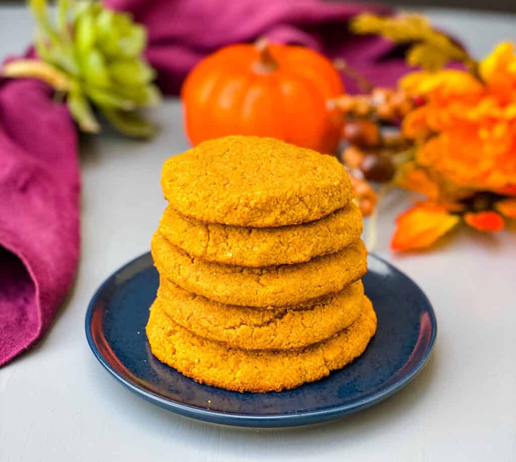 keto pumpkin cookies stacked on a blue plate