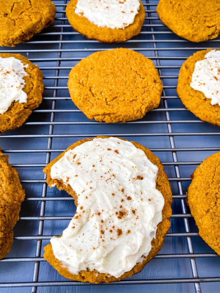 keto pumpkin cookies with icing on a cooling rack