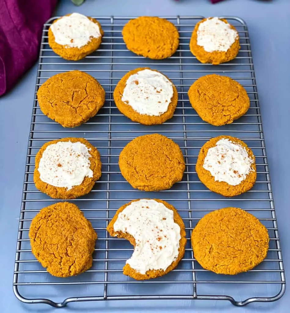 keto pumpkin cookies with icing on a cooling rack
