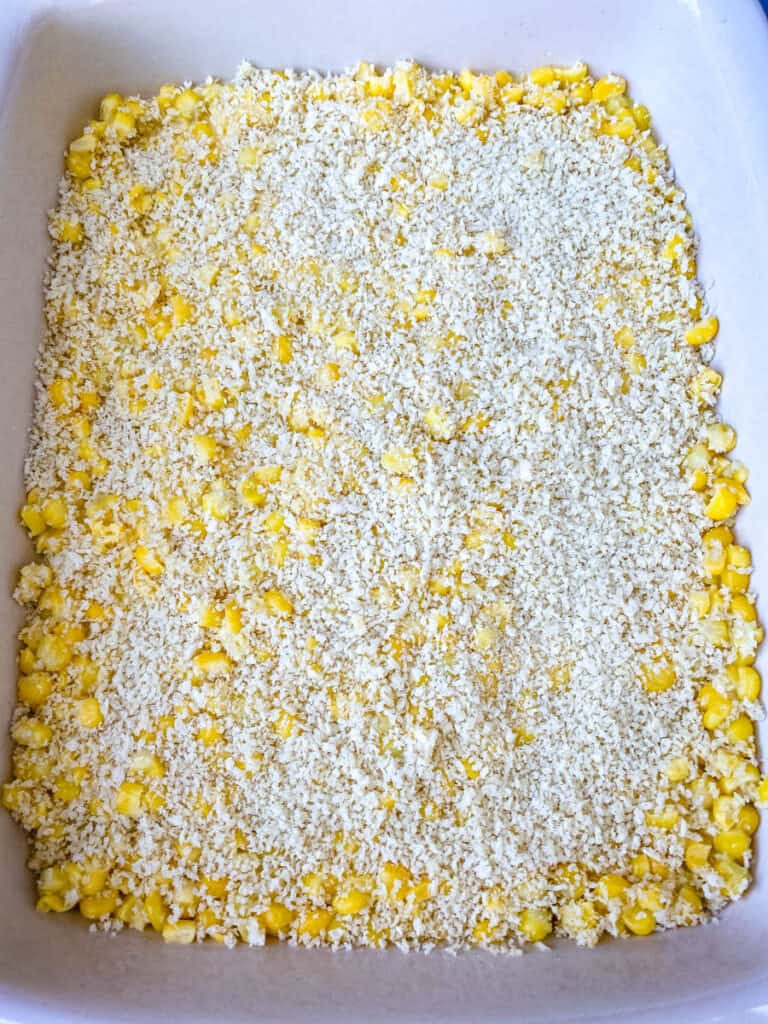 uncooked scalloped corn in a baking dish