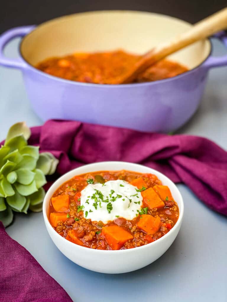 sweet potato chili in a Dutch oven and a white bowl