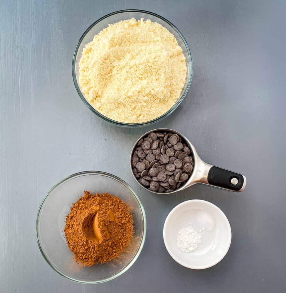 almond flour, unsweetened cocoa, chocolate chips, baking powder, and salt on a flat surface