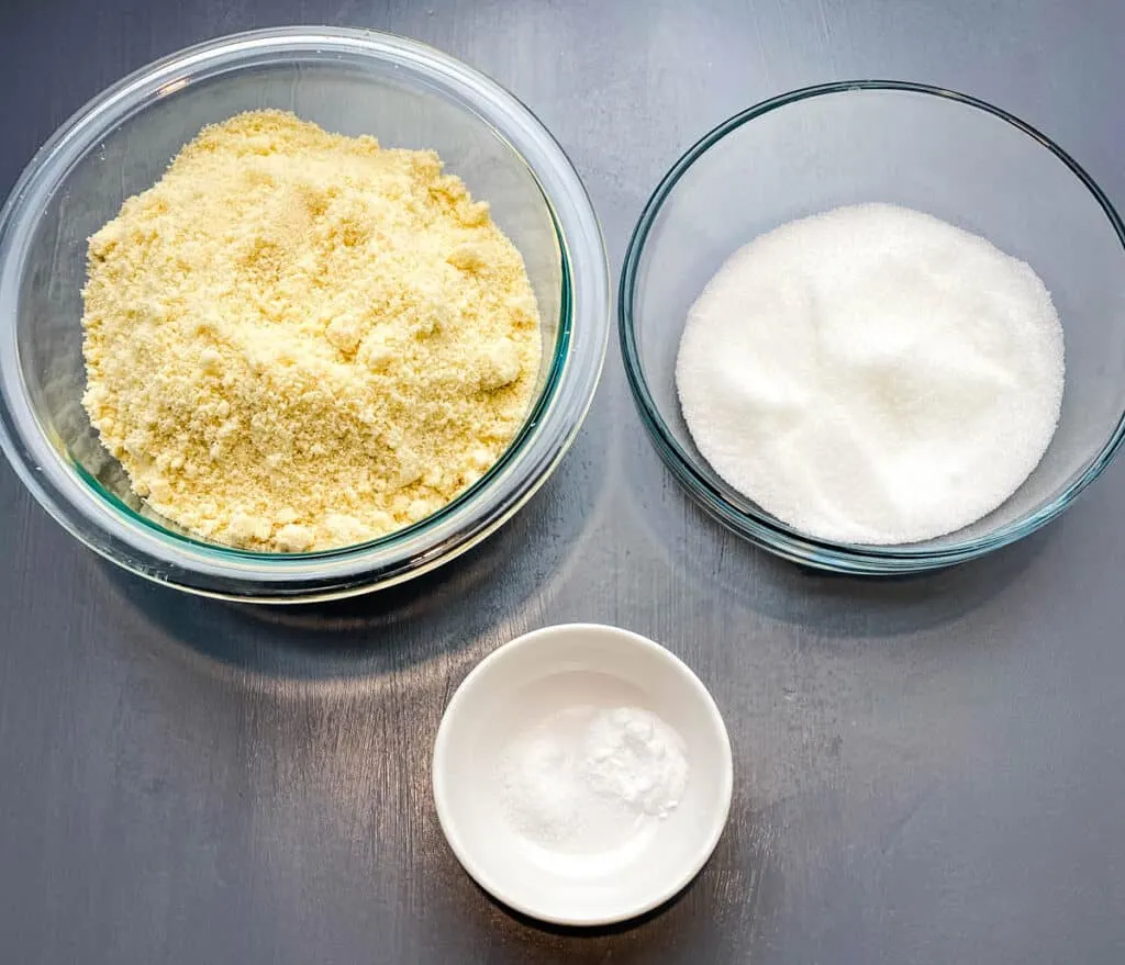 almond flour, sweetener, and baking soda in glass bowls on a flat surface