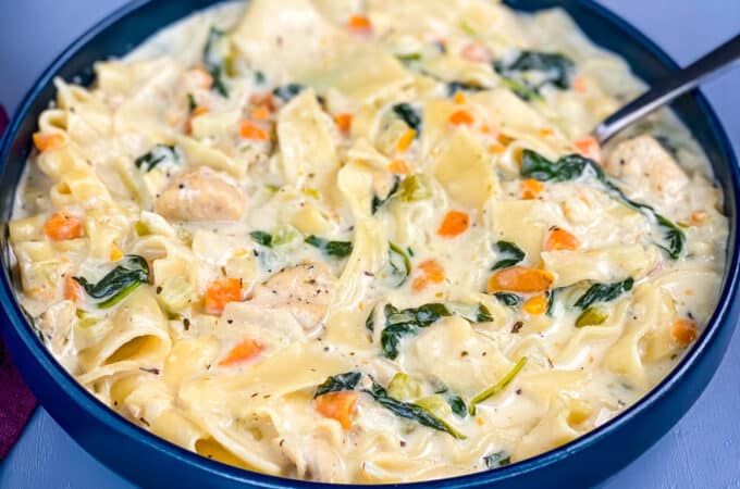 chicken lasagna soup in a blue bowl