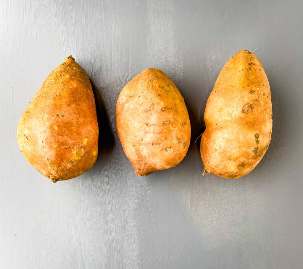 raw sweet potatoes on a flat surface