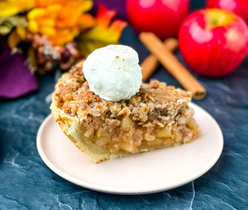 sugar free apple pie on a pink plate with vanilla ice cream