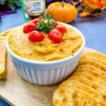 pumpkin hummus on a plate with crackers and cornbread