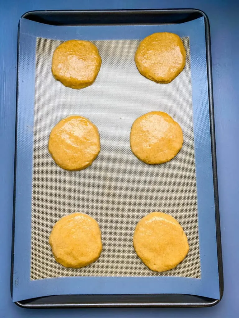 raw snickerdoodle cookies on a cookie sheet