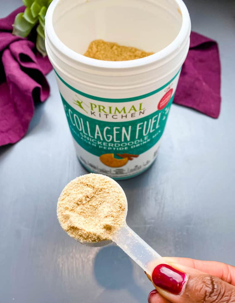 person holding a scoop of Primal Kitchen Snickerdoodle collagen