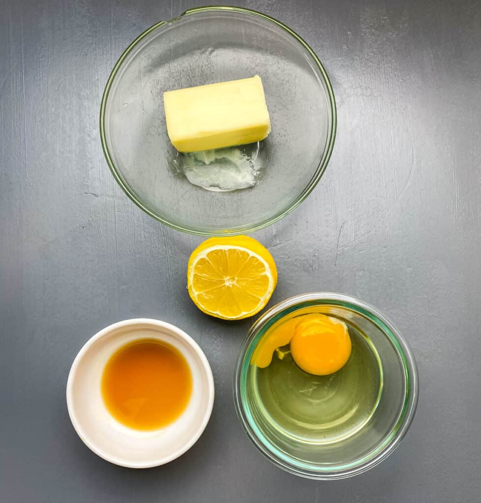butter, lemon, vanilla extract, and a raw egg in separate glass bowls