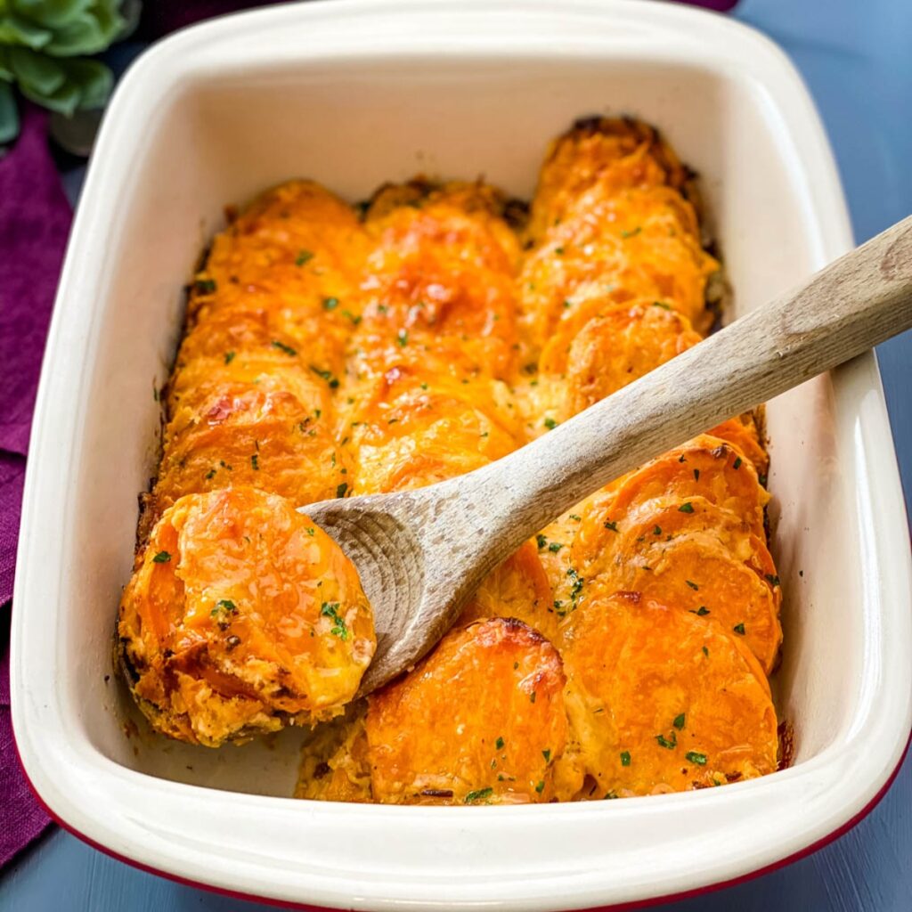 au gratin sweet potatoes in a red baking dish