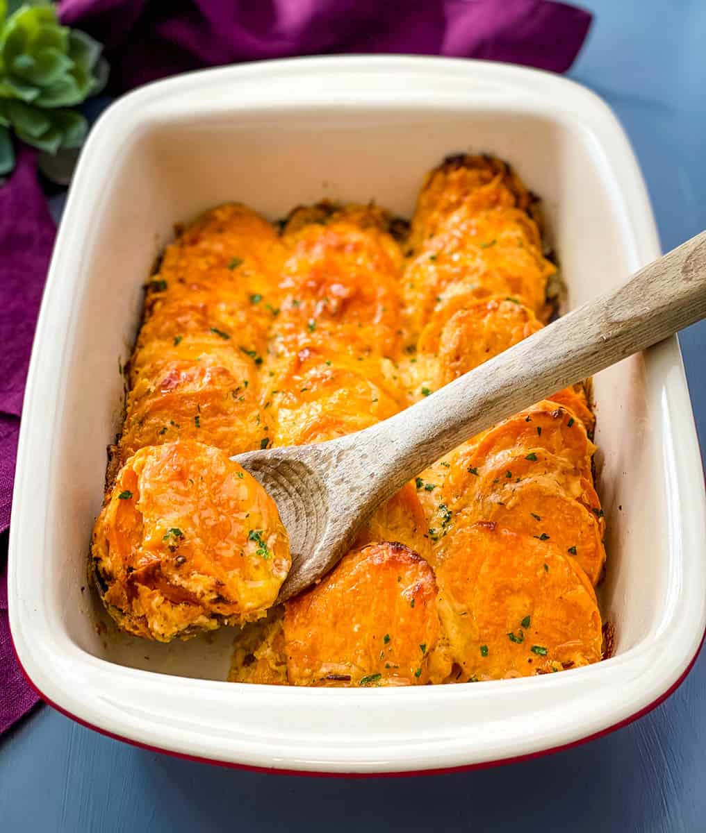 au gratin sweet potatoes in a red baking dish