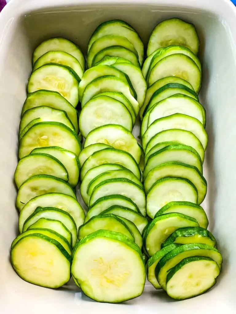 sliced round zucchini in a baking dish
