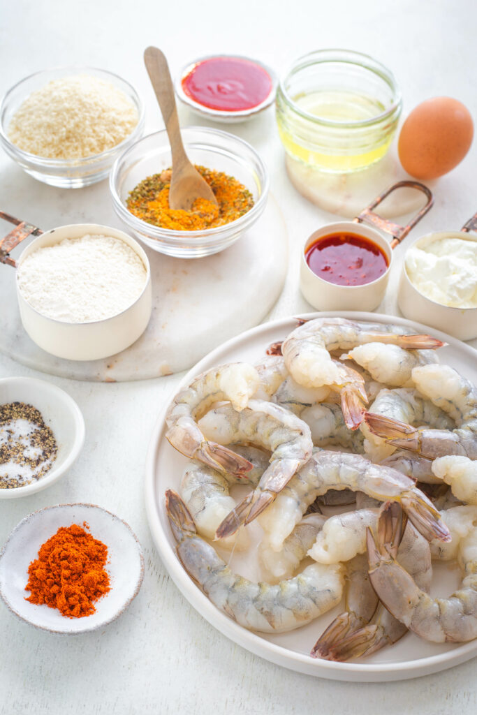 raw shrimp and breading in separate bowls