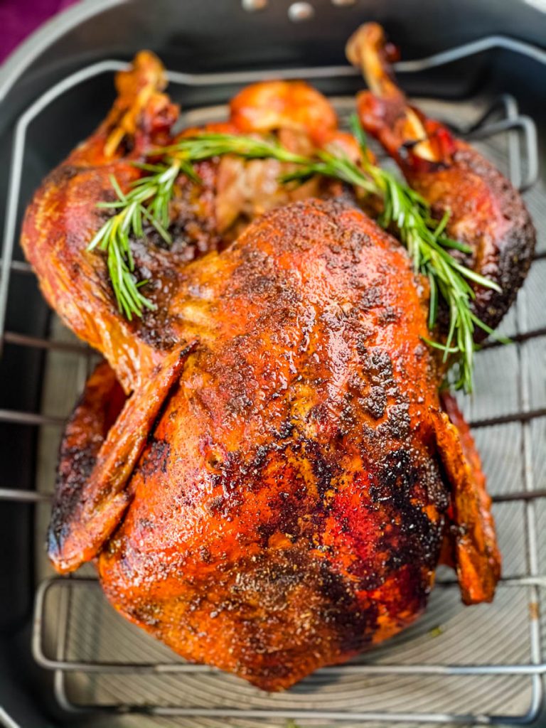 cajun roasted turkey in a roasting pan