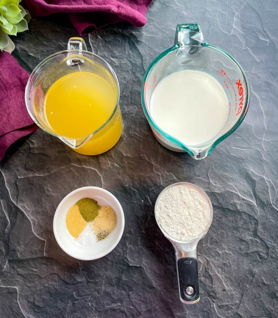 chicken broth, milk, flour, and seasonings on a flat surface