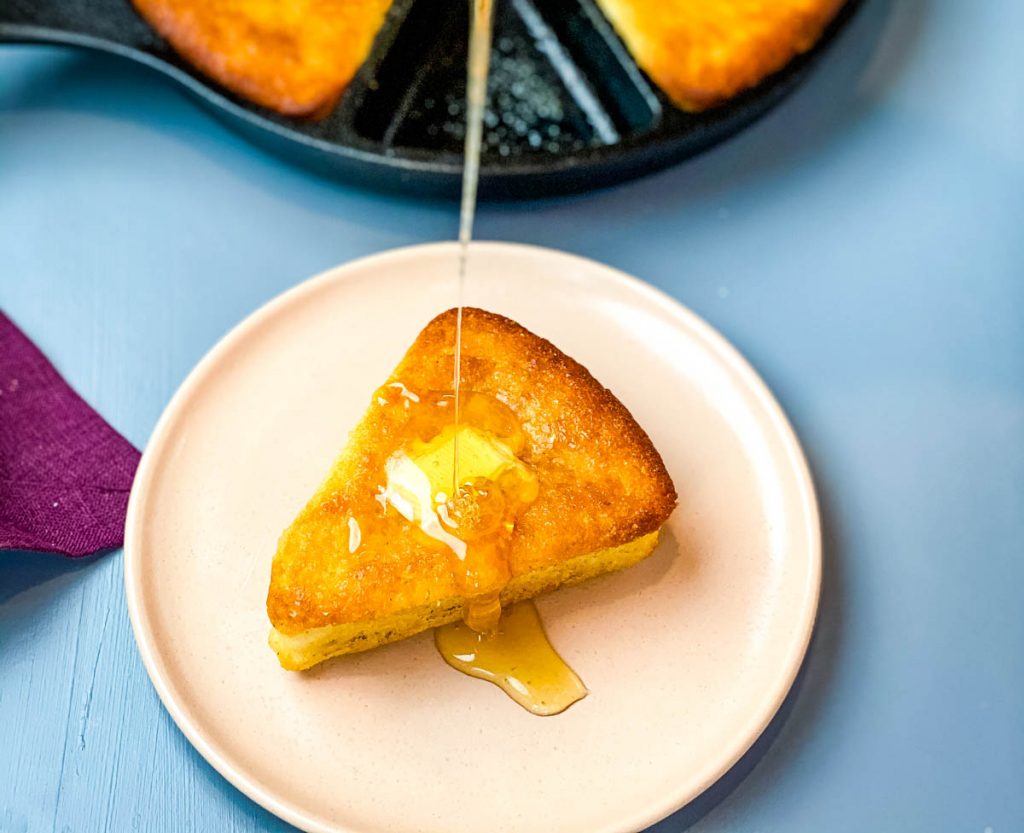 honey drizzled onto a slice of cornbread