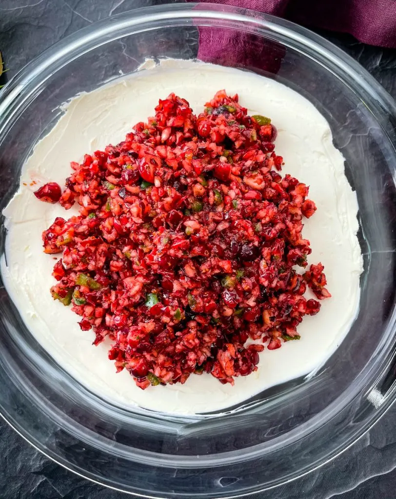 jalapeno cranberry dip with cream cheese in a glass bowl