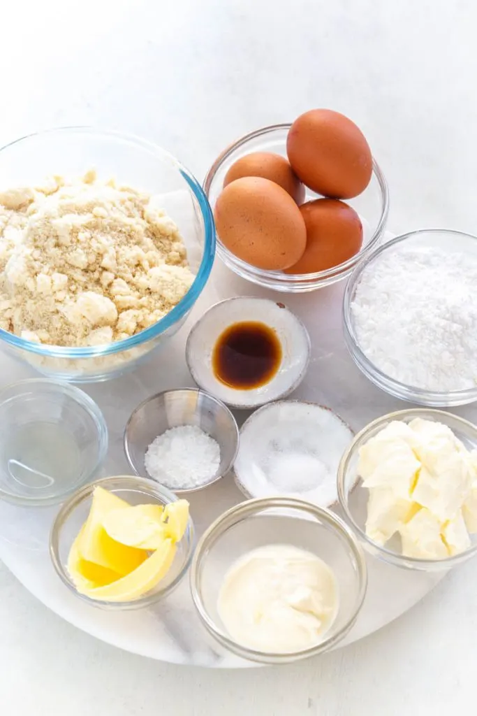 almond flour, raw eggs, butter, vanilla, and sweetener in separate bowls