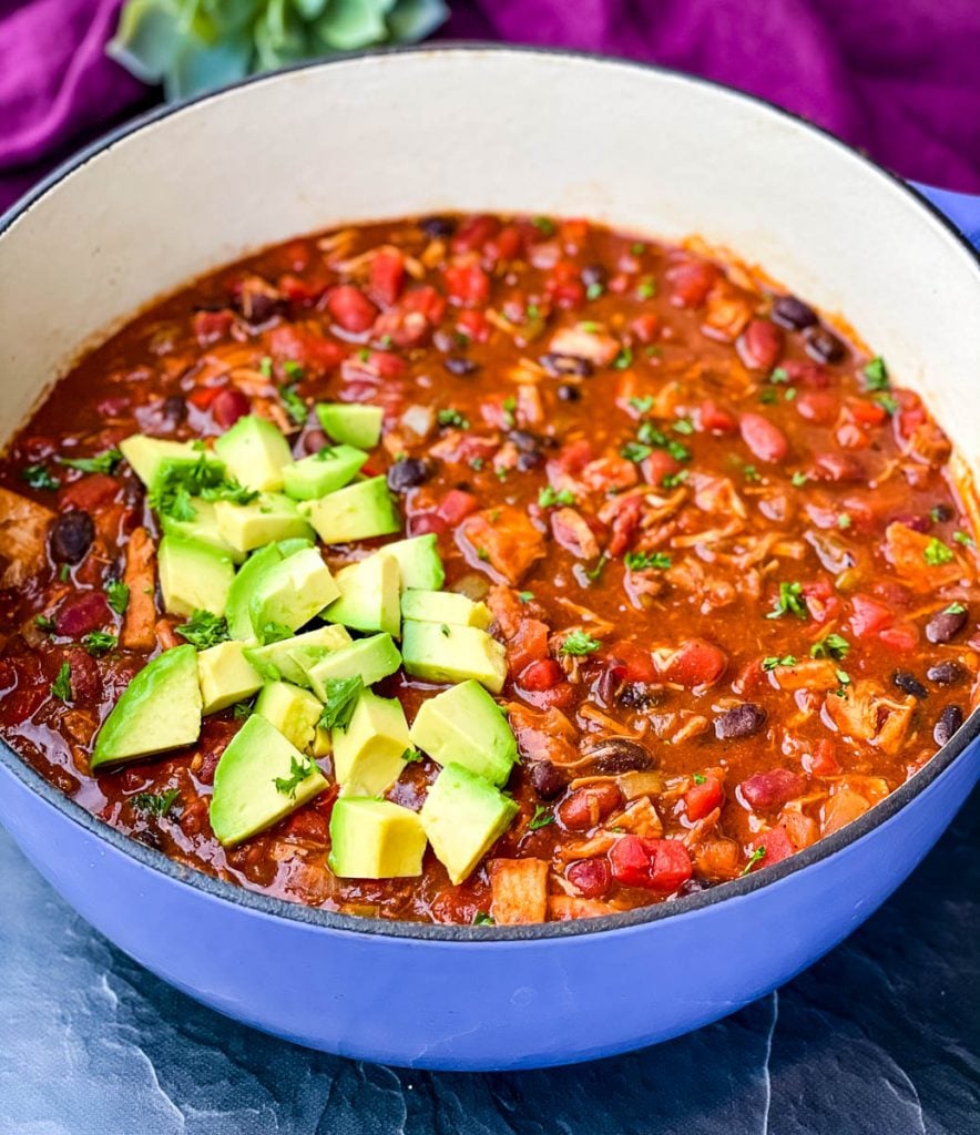 leftover turkey chili in a purple Dutch oven