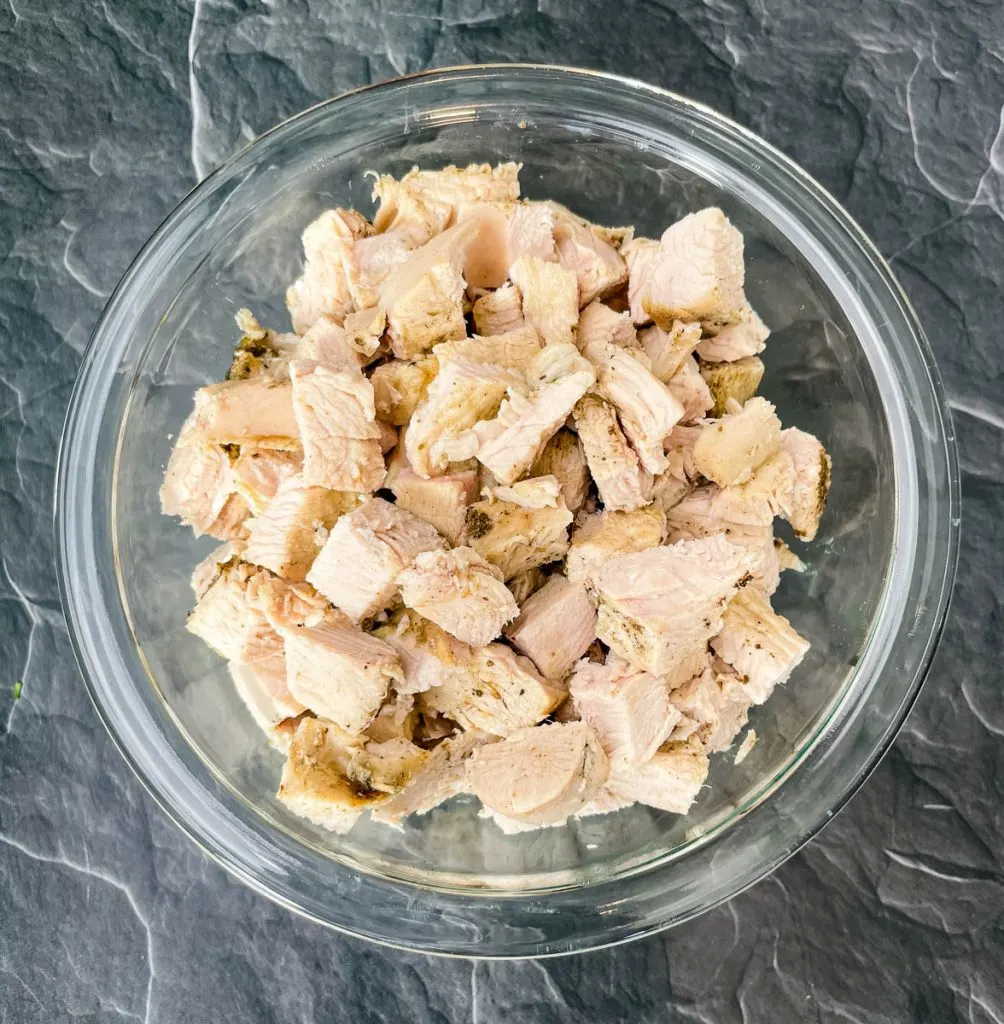 cooked turkey breast cubes in a glass bowl