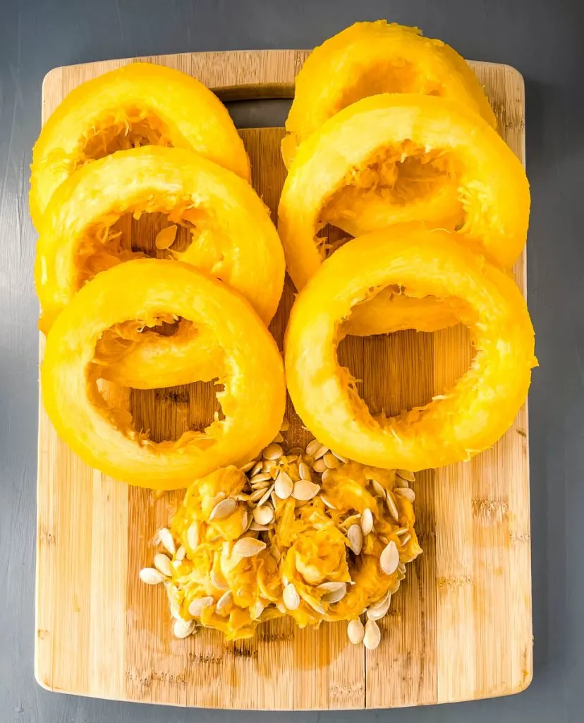 cooked spaghetti squash sliced on a cutting board