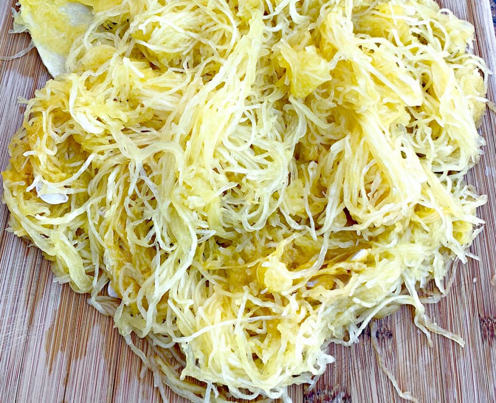 spaghetti squash strands on a bamboo cutting board