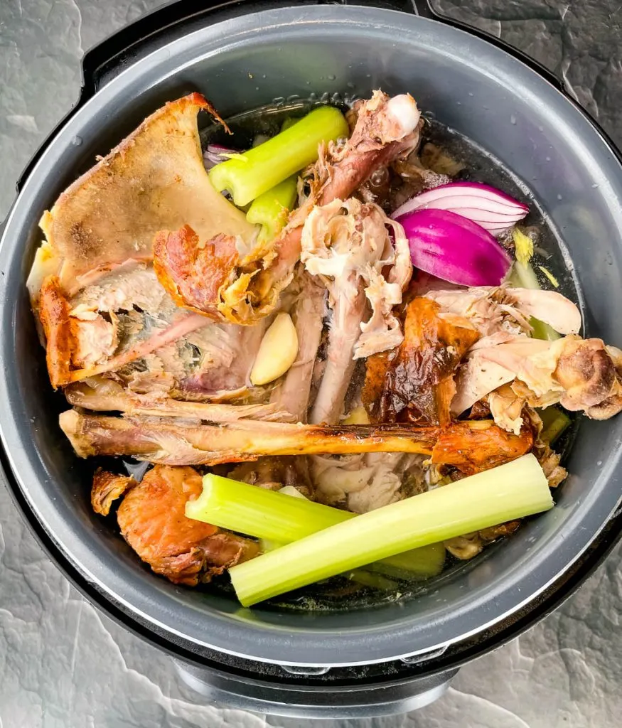 turkey bones, carcass, and fresh vegetables in an Instant Pot