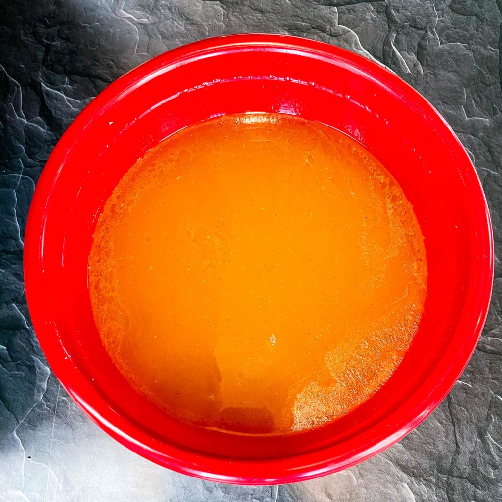 turkey bone broth in a red bowl