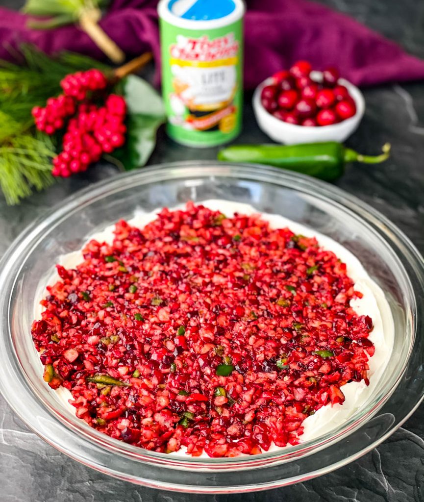 jalapeno cranberry dip with cream cheese in a glass bowl