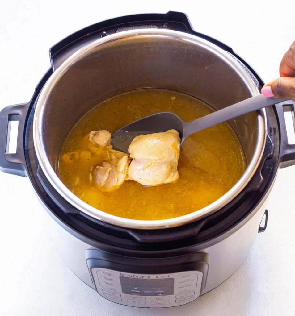 cooked chicken thighs in an Instant Pot with broth