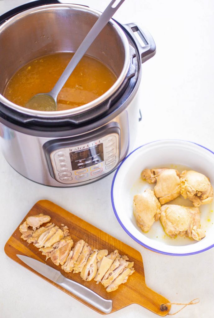 cooked chicken thighs in an Instant Pot with broth