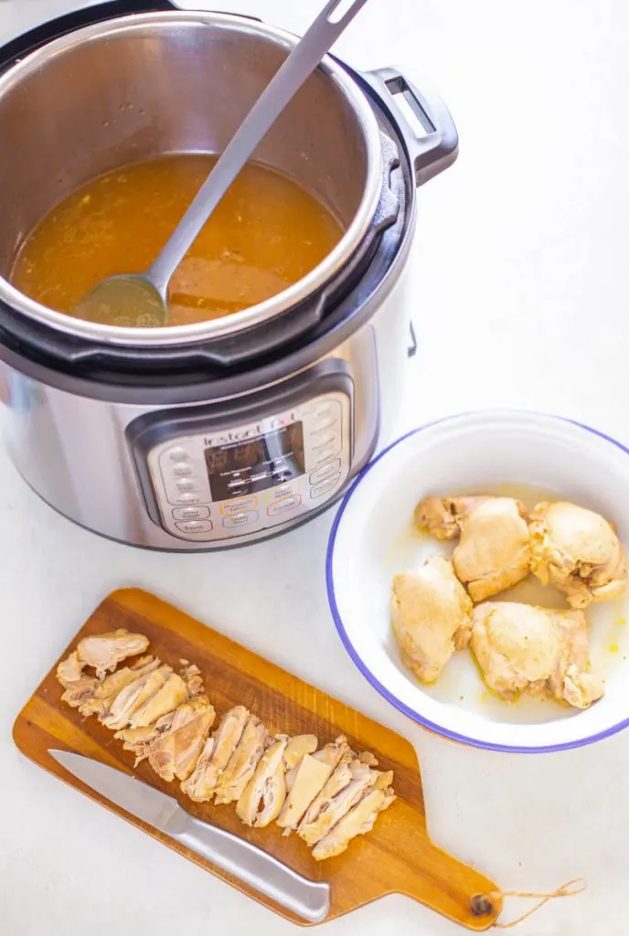 cooked chicken thighs in an Instant Pot with broth
