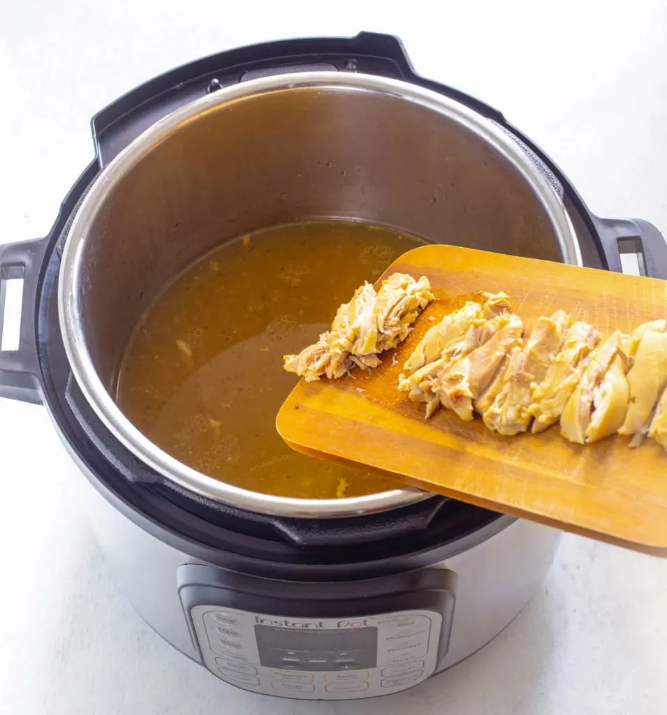 sliced chicken thighs in broth in an Instant Pot