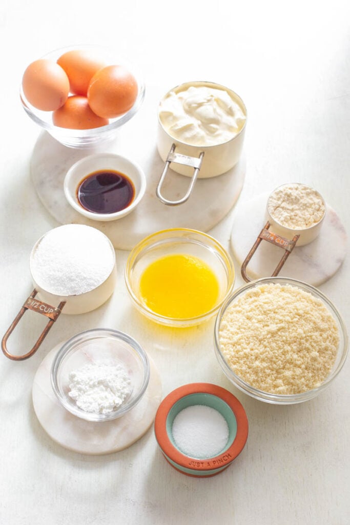 sweetener, melted butter, vanilla, almond flour, cream cheese, and whole eggs in separate bowls