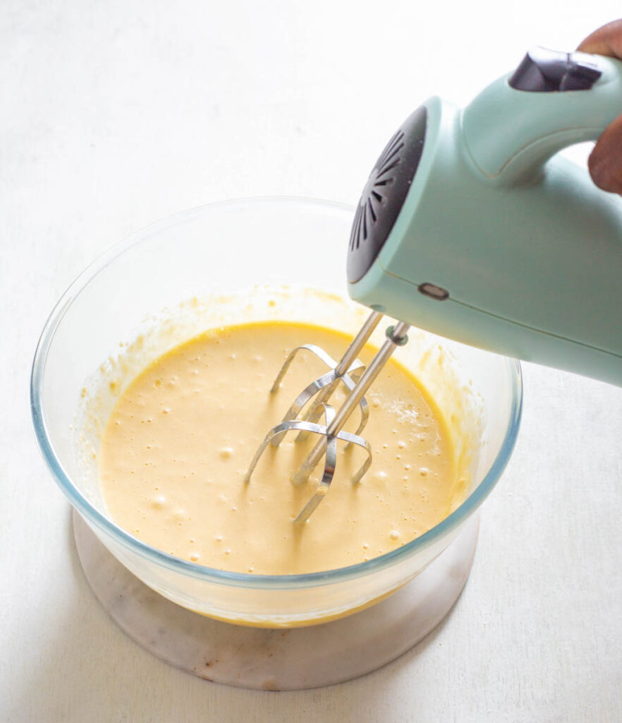 sugar free cupcake batter in a glass bowl with a hand mixer