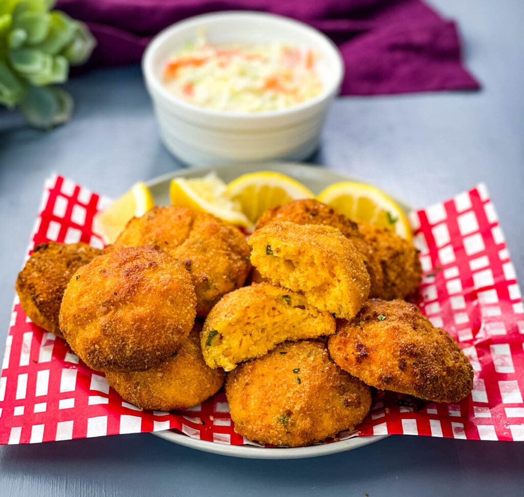 air fryer hushpuppies on a plate with fried fish and coleslaw