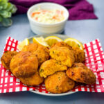 air fryer hushpuppies on a plate with fried fish and coleslaw