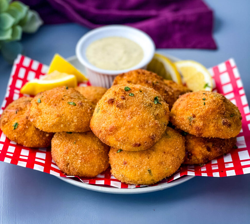 air fryer hushpuppies on a plate with tartar sauce