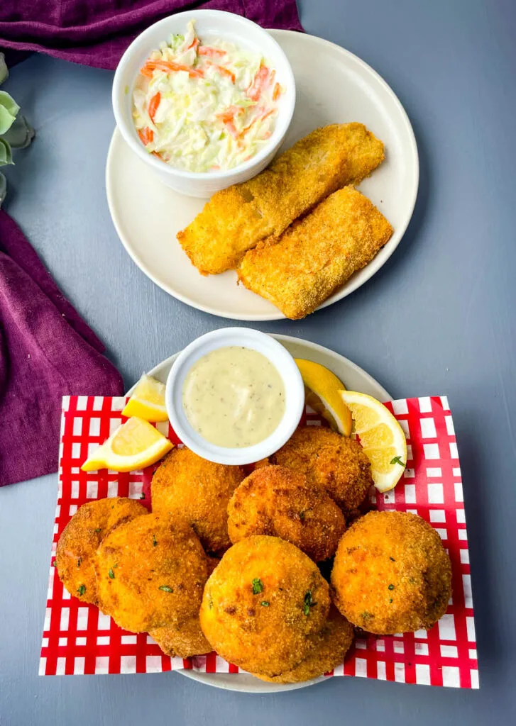 air fryer hushpuppies on a plate with fried fish and coleslaw