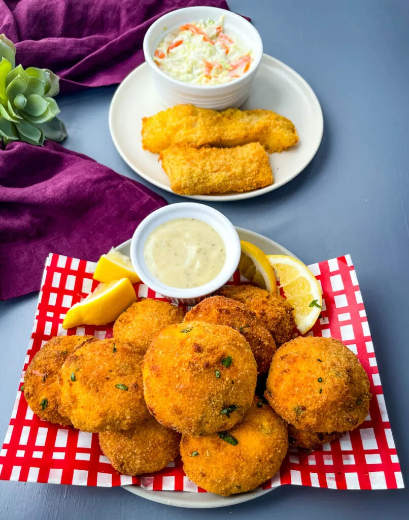 air fryer hushpuppies on a plate with fried fish and coleslaw