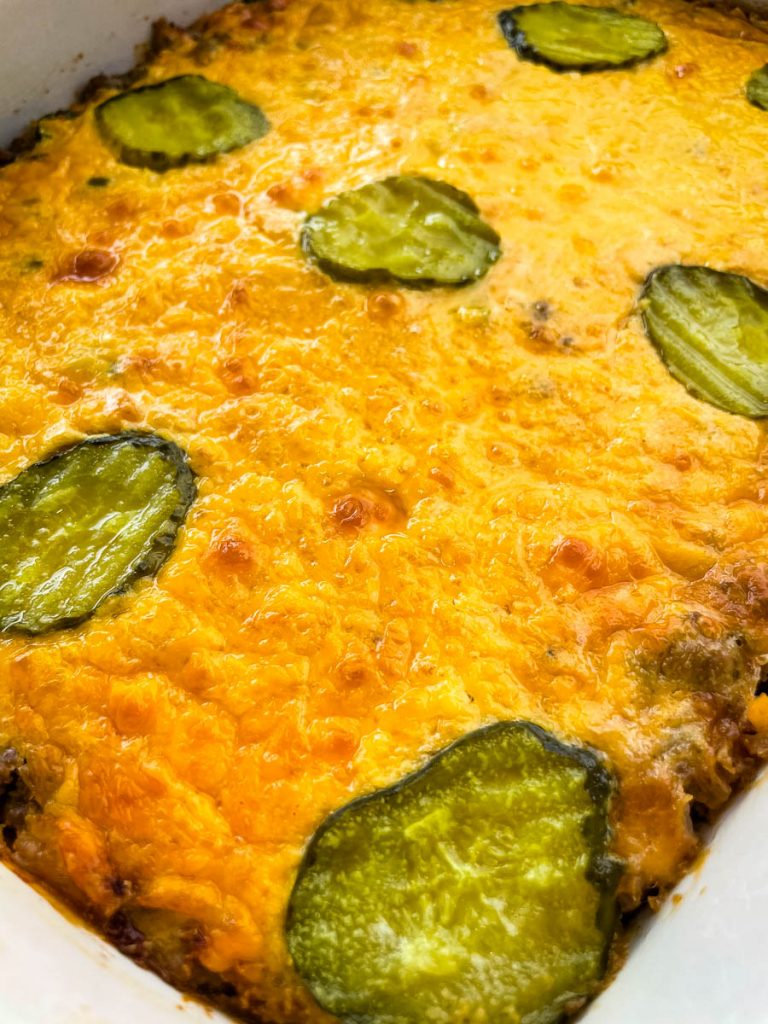 Big Mac Casserole in a baking dish topped with pickles